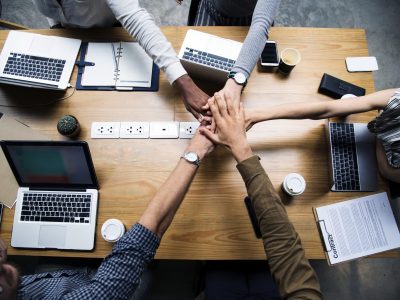 Team of business people stacking hands