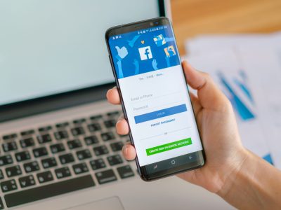 Loei, Thailand - May 10, 2017: Hand holding samsung s8 with mobile application for Facebook on the screen